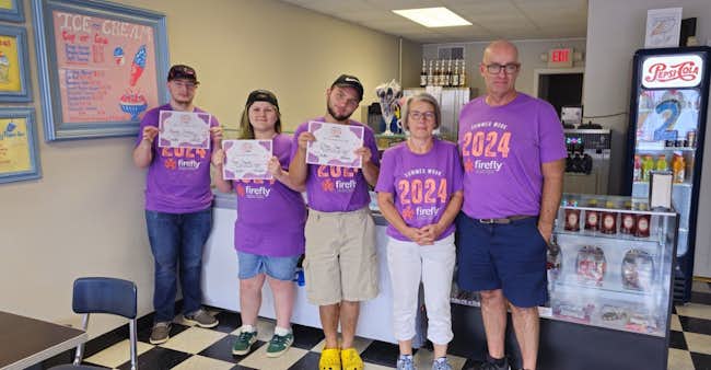Firefly Summer Work students with Blue Jay Scoops owners Lisa Barber and Lyle Barber in Clever.